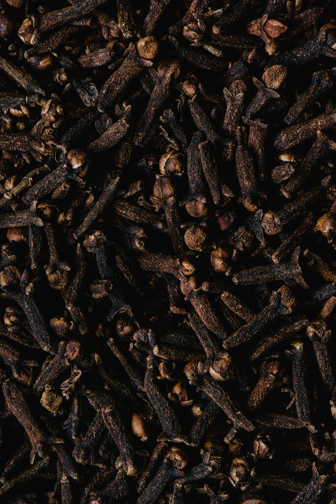 Close-up view of aromatic dried cloves, showcasing texture and rich brown color.